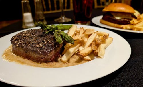 Steak dinner with fries and asparagus
